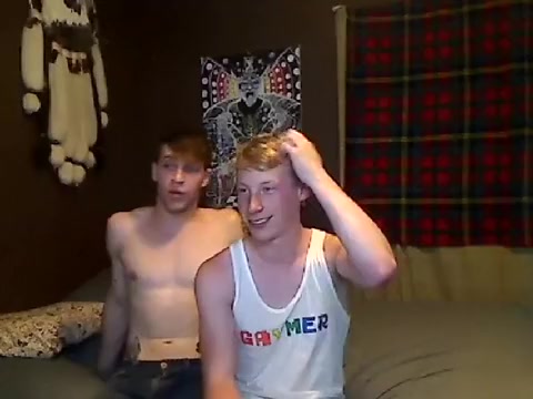Handsome gay is beating off within doors and filming himself on camera