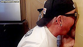 Homemade DILF sucks ands wanks penis through gloryhole