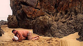 Men Wrestling On The Beach
