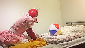 Rubber fox maid plays with beach ball